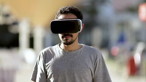 Cheerful-man-in-VR-headset-on-street